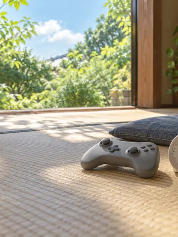 畳の上のゲームパッドと1時間に合わせたタイマー